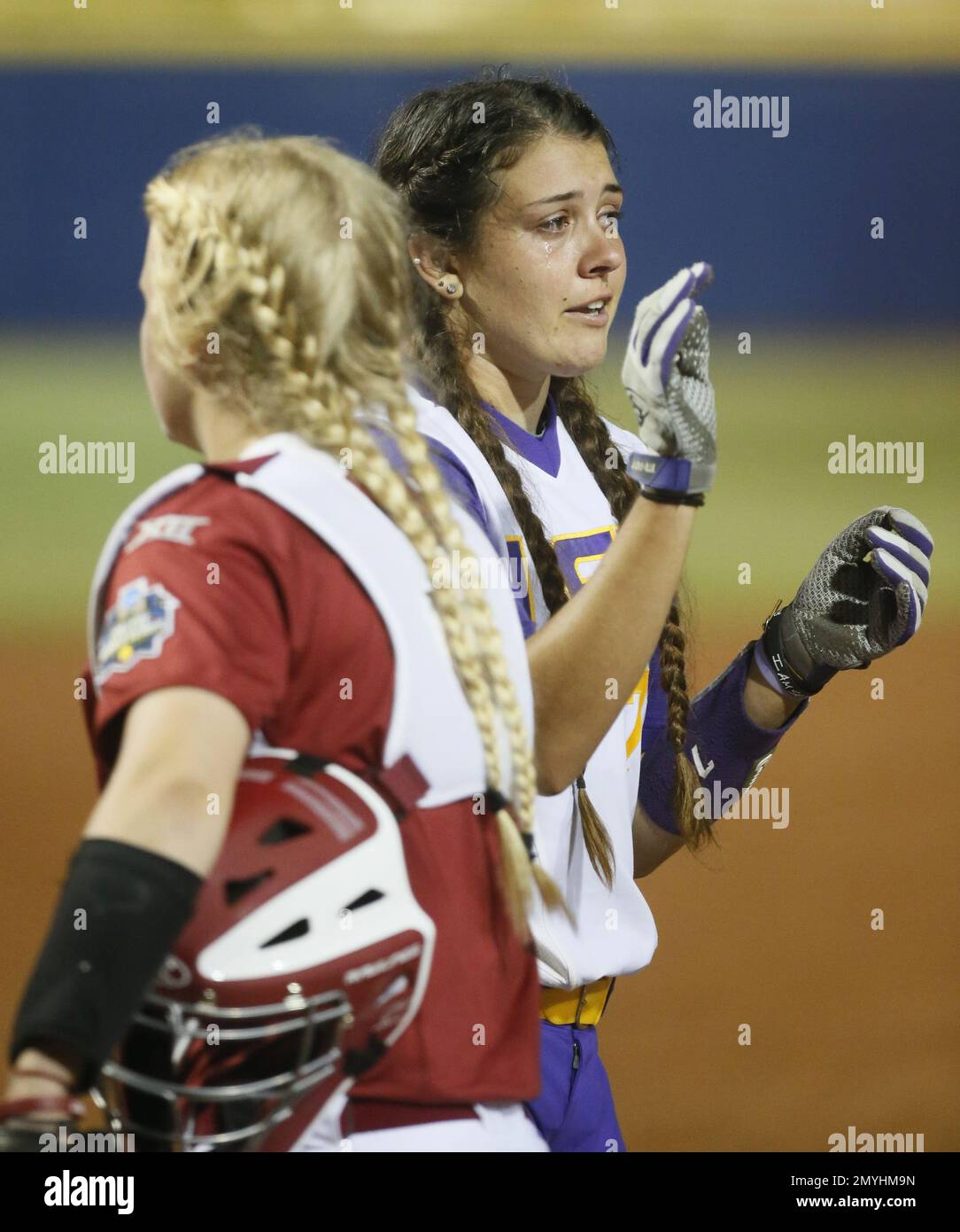 LSU catcher Kellsi Kloss, right, cries as she highfives Oklahoma