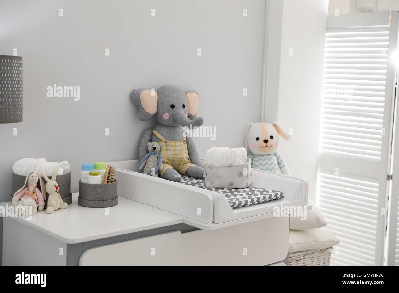 Changing tray and pad on chest of drawers in baby room. Interior design