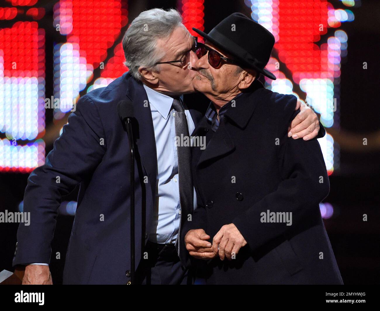 Robert DeNiro, left, kisses Joe Pesci as they accept the guy movie hall