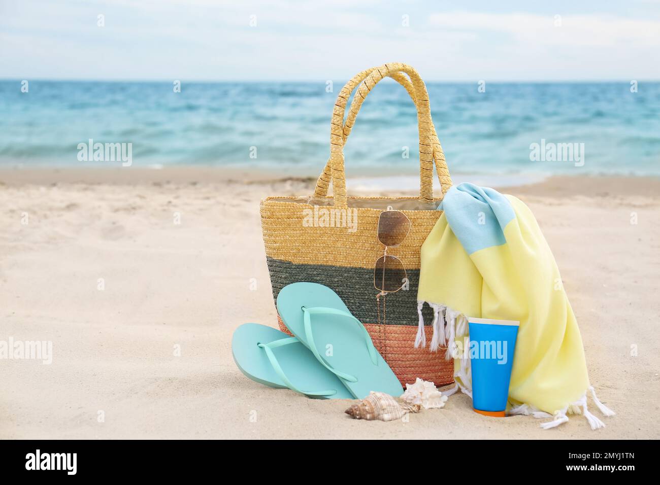Different stylish beach objects and seashells on sand near sea Stock ...