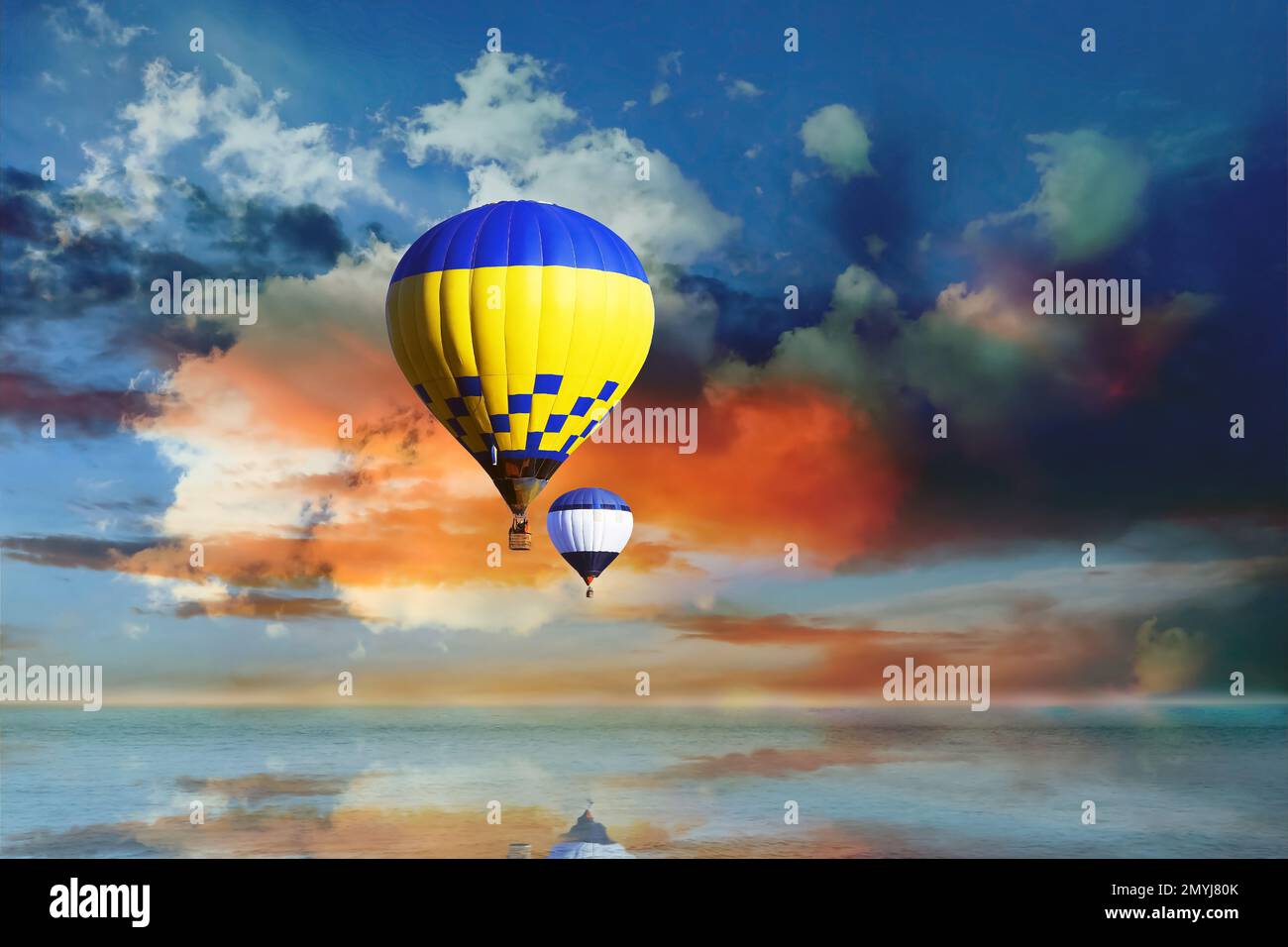 Fantastic dreams. Hot air balloons in blue sky with clouds over sea