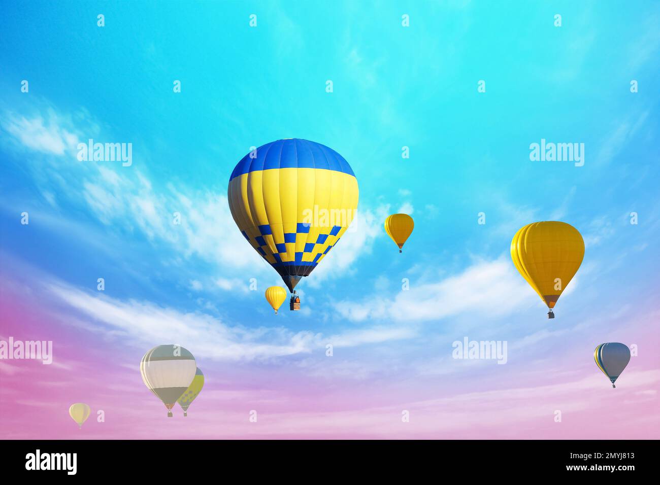 Fantastic dreams. Hot air balloons in bright sky with clouds Stock