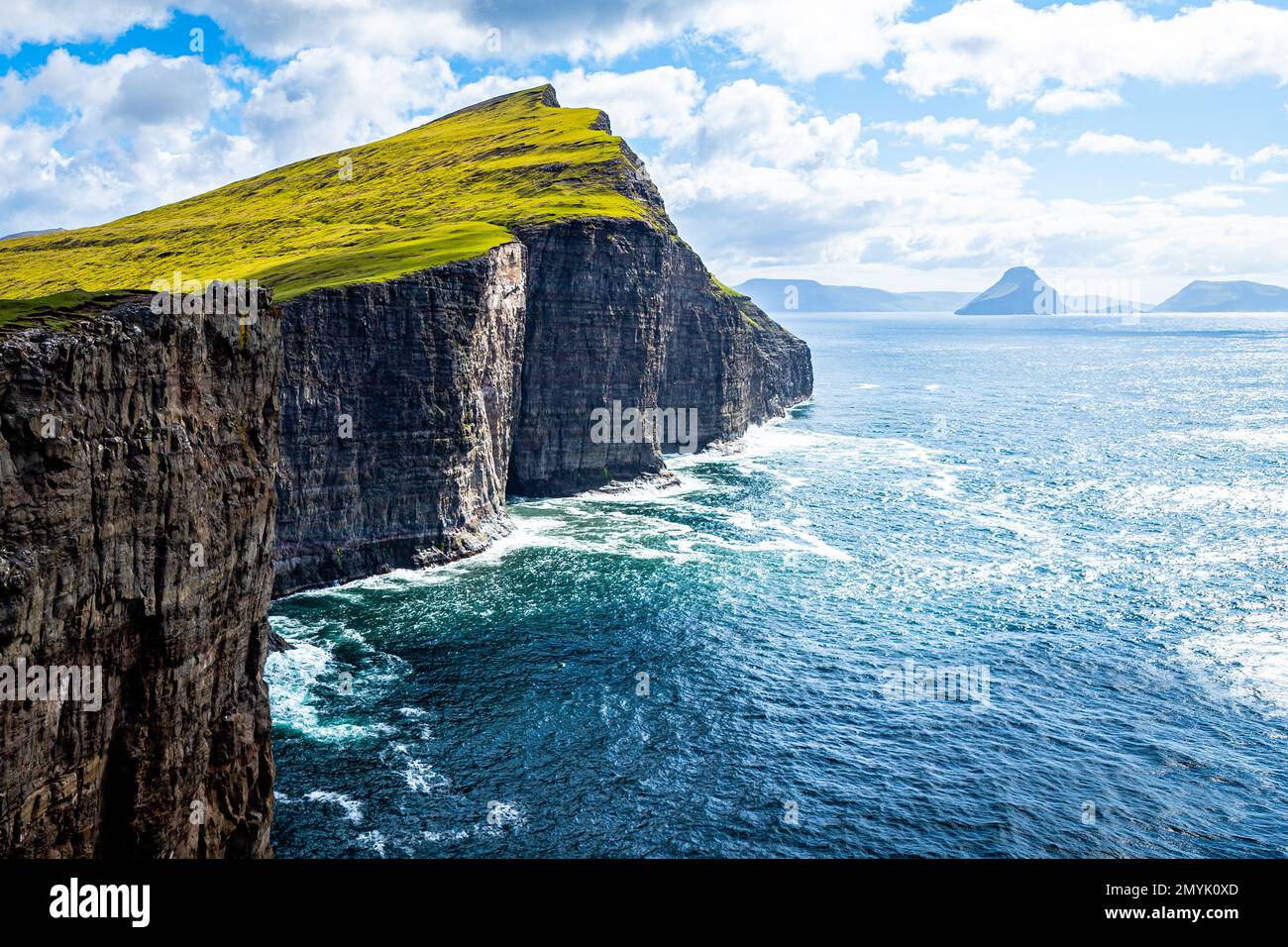 Shear coastal cliffs of Trælanípa (Slave Cliff) near Sandavagur, Vagar, Faroe Islands on a sunny day Stock Photo