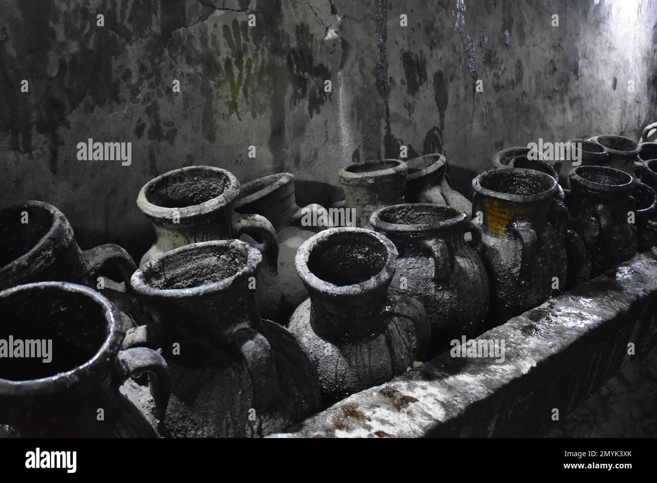 Clay pots hold olive oil for lamps burning in the holy Yazidi shrine of