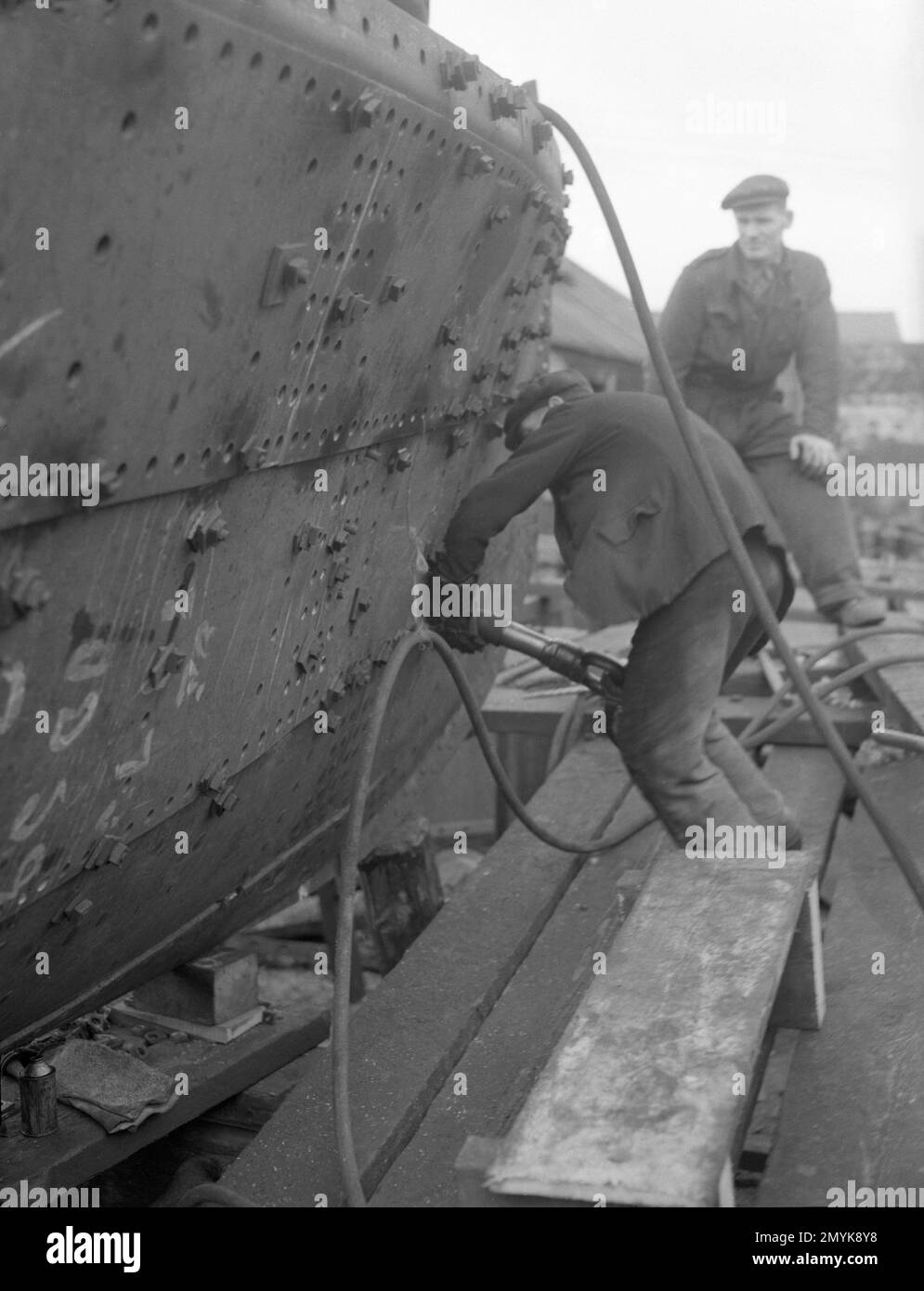 Riveters working on the smallest all steel vessel ever built on