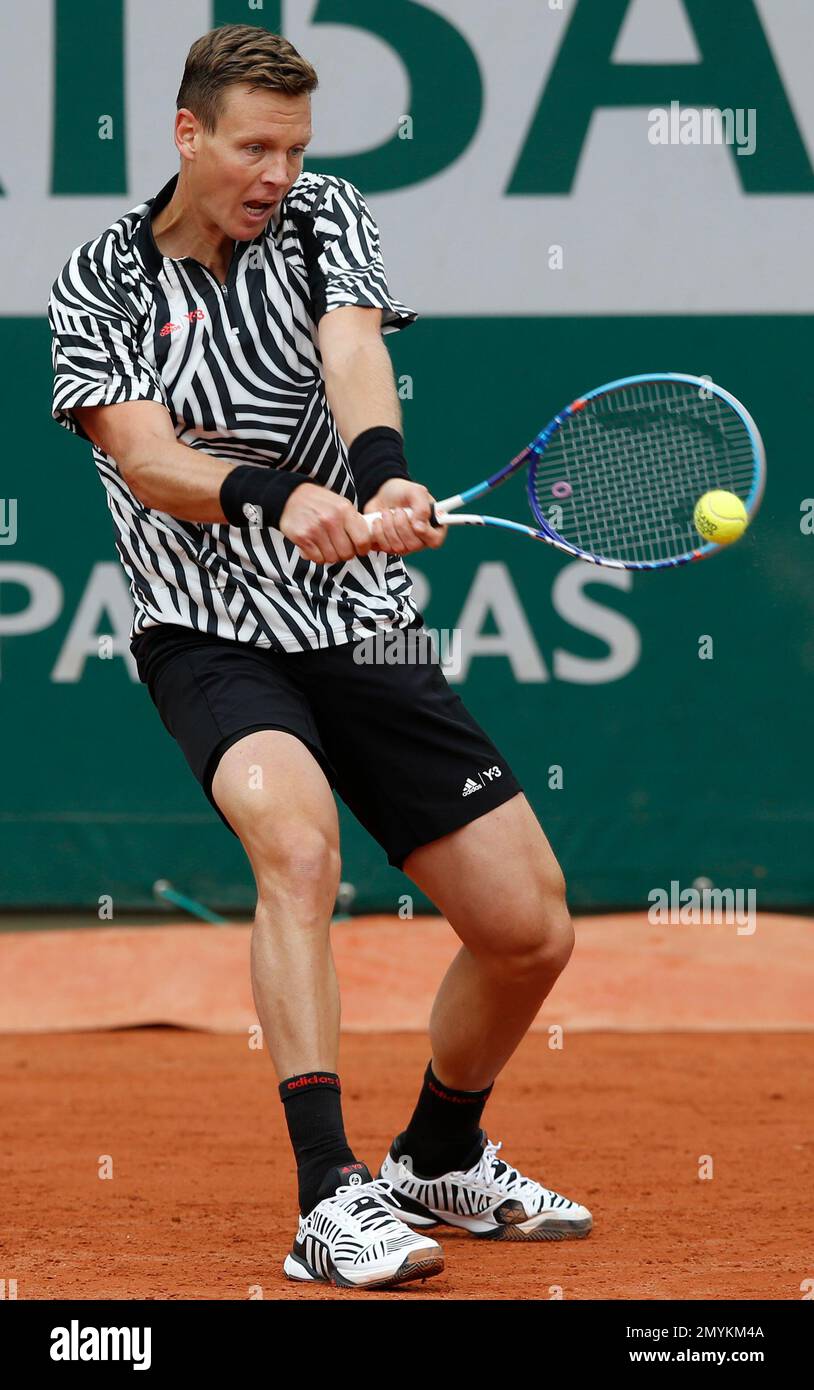 Tomas Berdych of the Czech Republic returns the ball to Canada's Vasek  Pospisil during their first round match of the French Open tennis  tournament at the Roland Garros stadium, Tuesday, May 24,