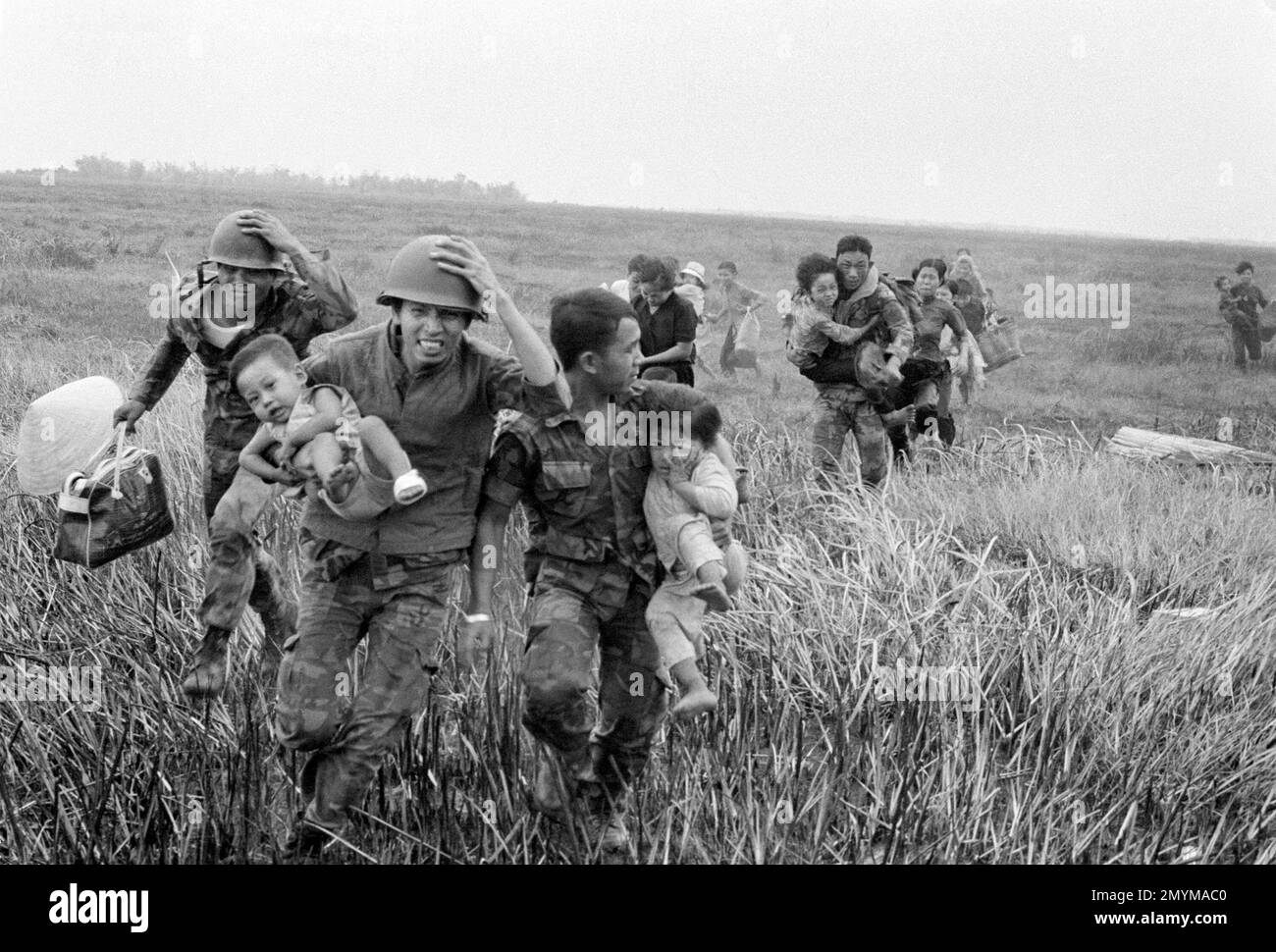 South Vietnamese Rangers rush children to a helicopter for evacuation ...