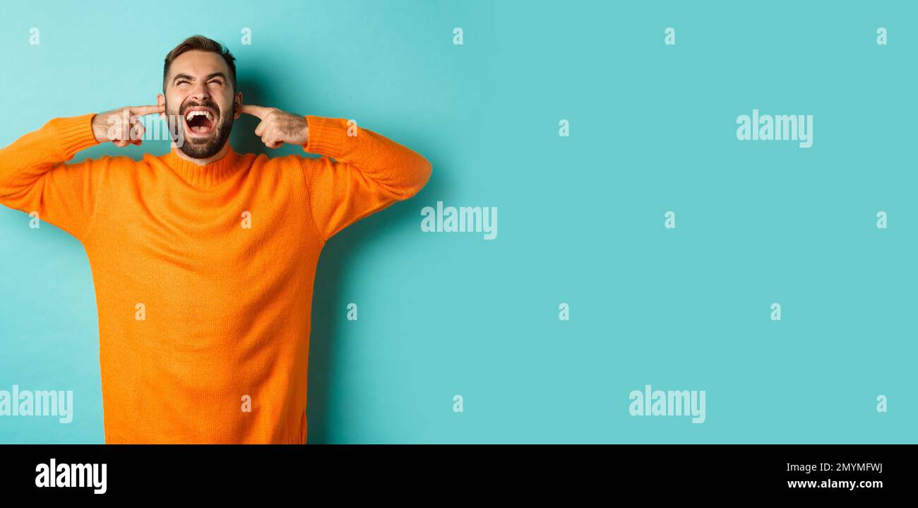 Frustrated and annoyed man shouting at neighbours upstairs, shut ears