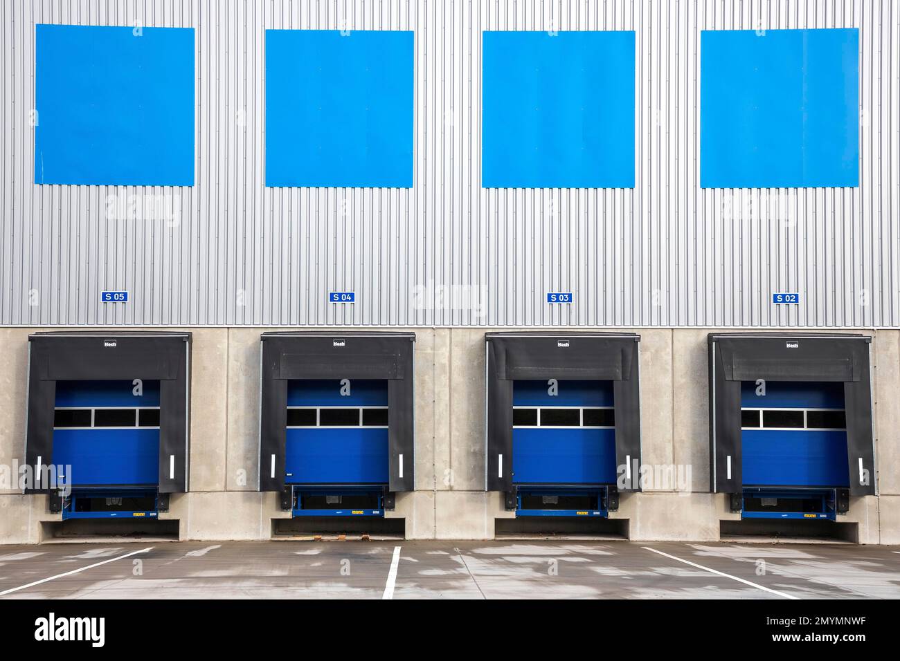 4 blue loading ramps at warehouse, Duisburg, North RhineWestphalia