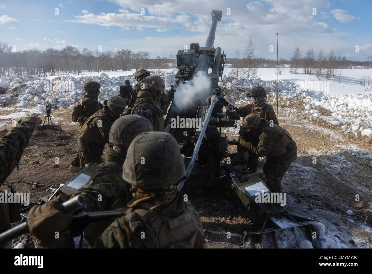 U.S. Marines with 3d Battalion, 12th Marines reload an M777 towed 155 mm howitzer while conducting live-fire training during Artillery Relocation Training Program 22.4 at the Yausubetsu Maneuver Area, Hokkaido, Japan, Jan. 30, 2023. The skills developed at ARTP increase the proficiency and readiness of the only permanently forward-deployed artillery unit in the Marine Corps, enabling them to provide precision indirect fires. (U.S. Marine Corps photo by Lance Cpl. Jaylen Davis.) Stock Photo