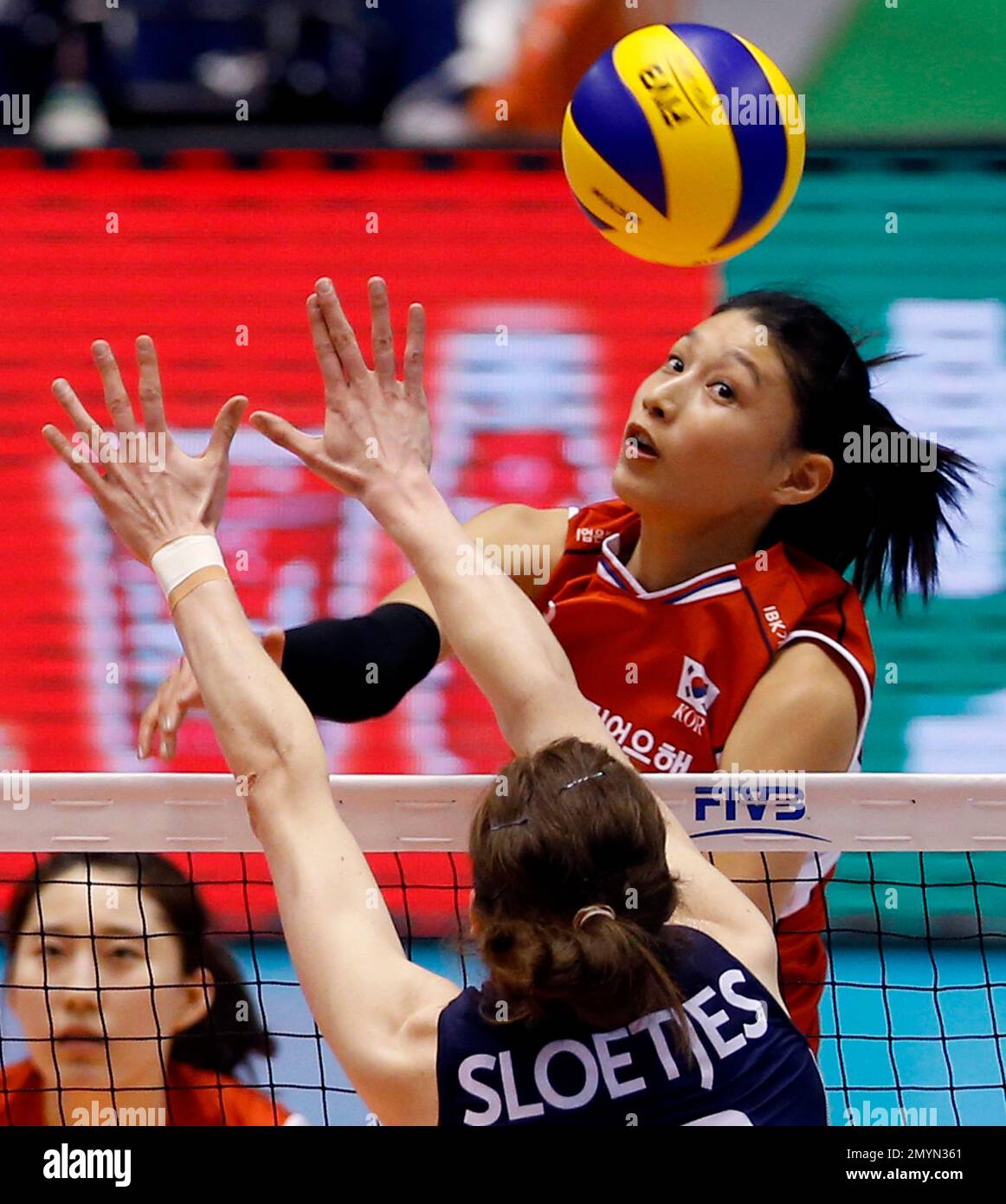 Kim Yeonkoung of South Korea spikes the ball against Lonneke Sloetjes