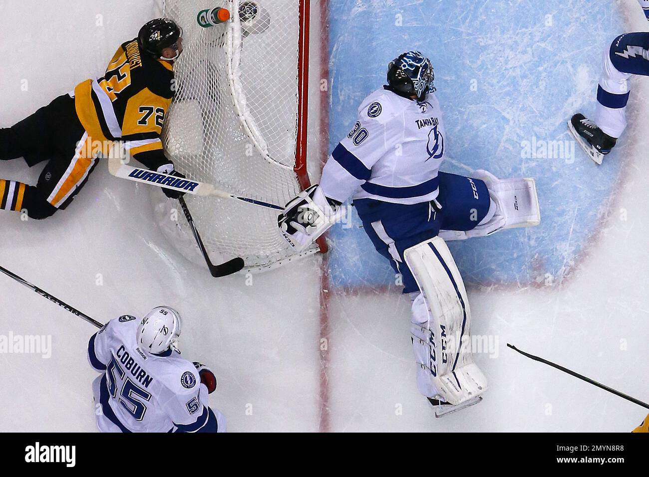 Pittsburgh Penguins' Patric Hornqvist (72) falls against the back of