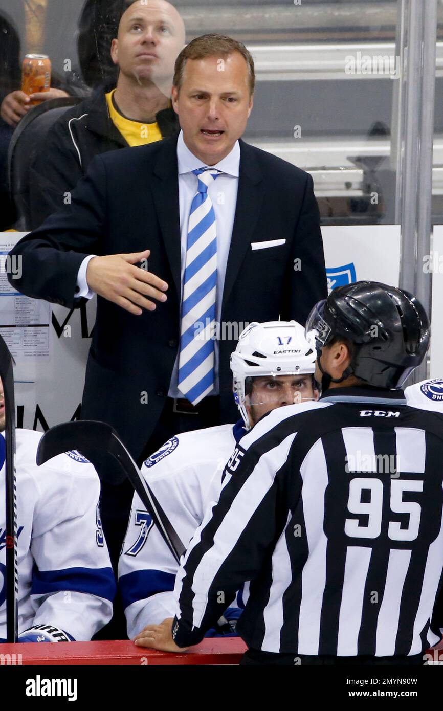 Tampa Bay Lightning coach Jon Cooper, top, talks with linesman Jonny