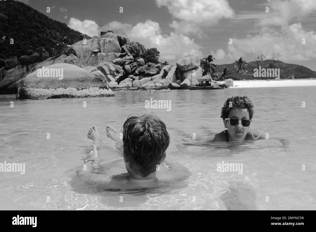 European tourists lying in shallow water by the sea, 1982, Koh Tao, Thailand, Asia Stock Photo