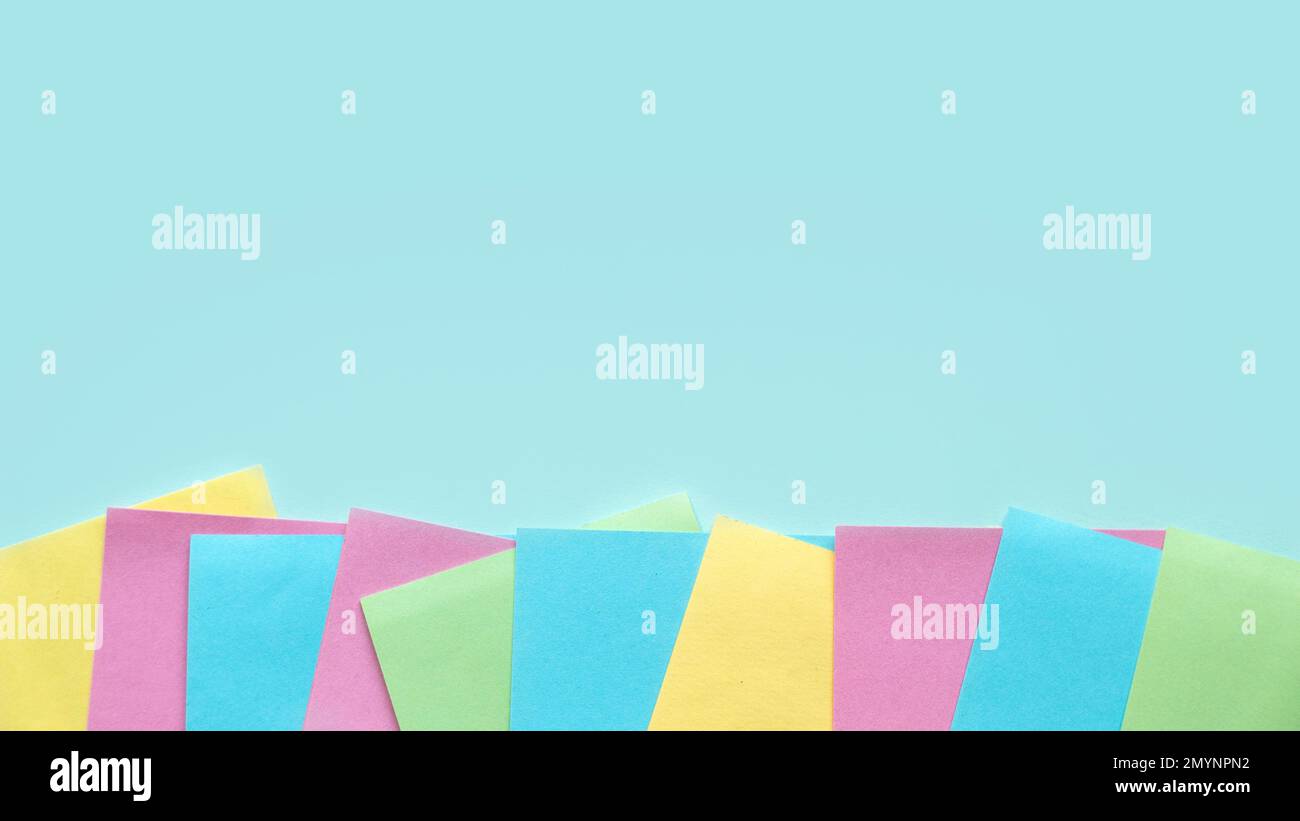 Copy space background with a multi color empty sticky paper note. Stock Photo