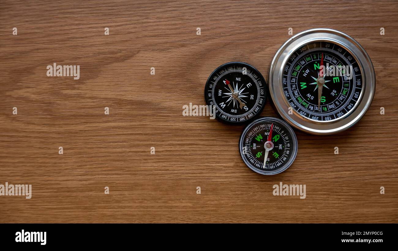 Compass on a wooden background with copy space. Stock Photo