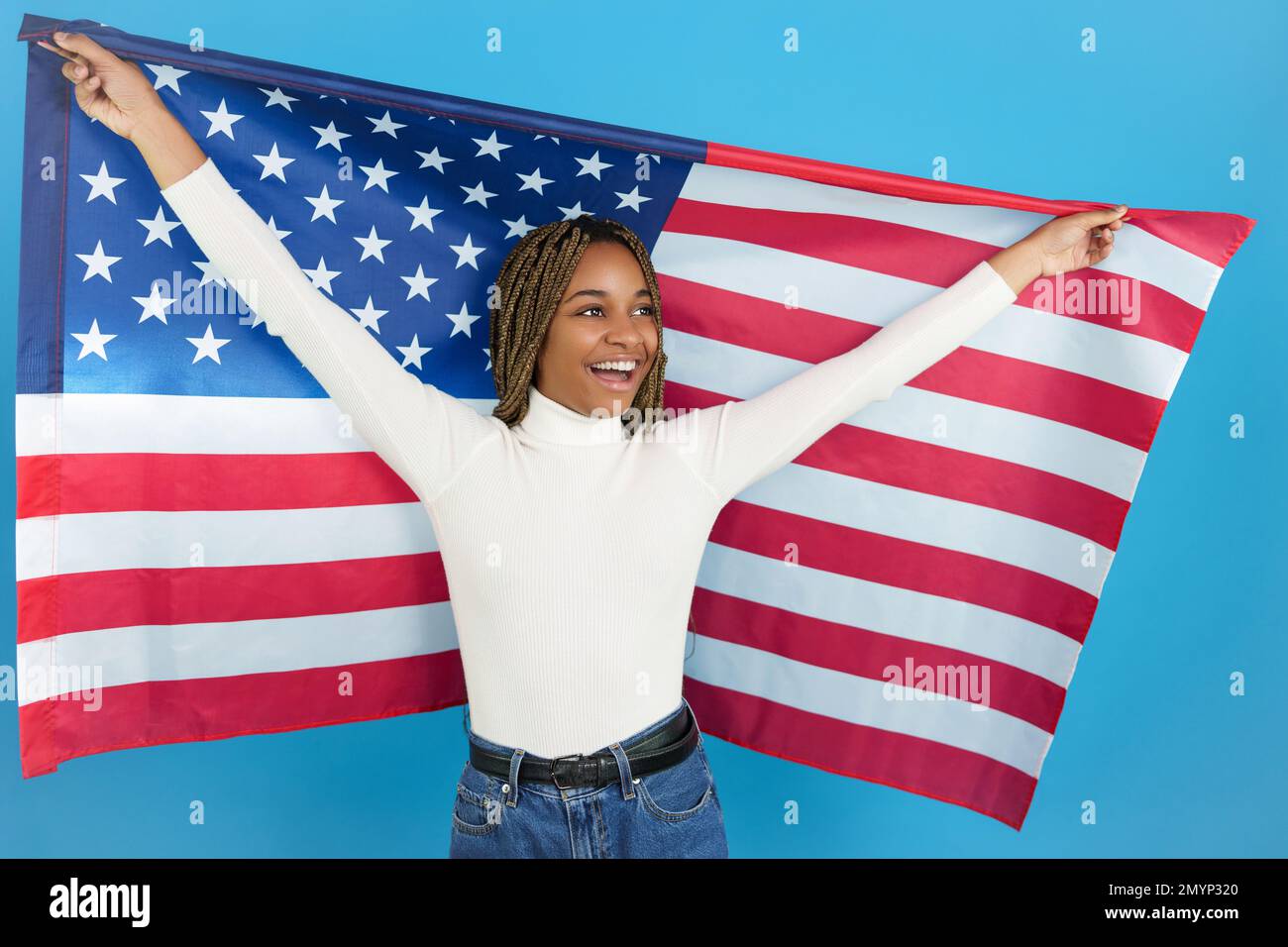 Happy african woman raising an American flag Stock Photo
