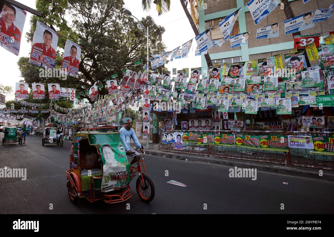 Layers of election campaign posters hang outside a voting center 