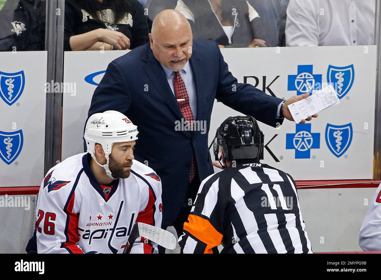 Washington Capitals head coach Barry Trotz, center, talks with referee
