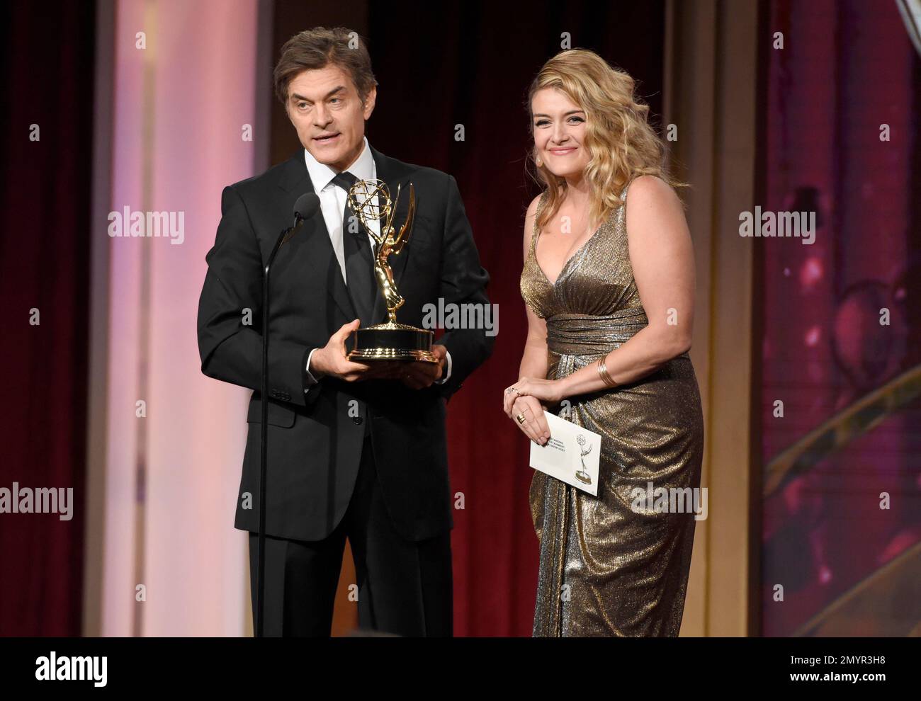 Dr. Mehmet Oz, left, and Daphne Oz present the award for outstanding