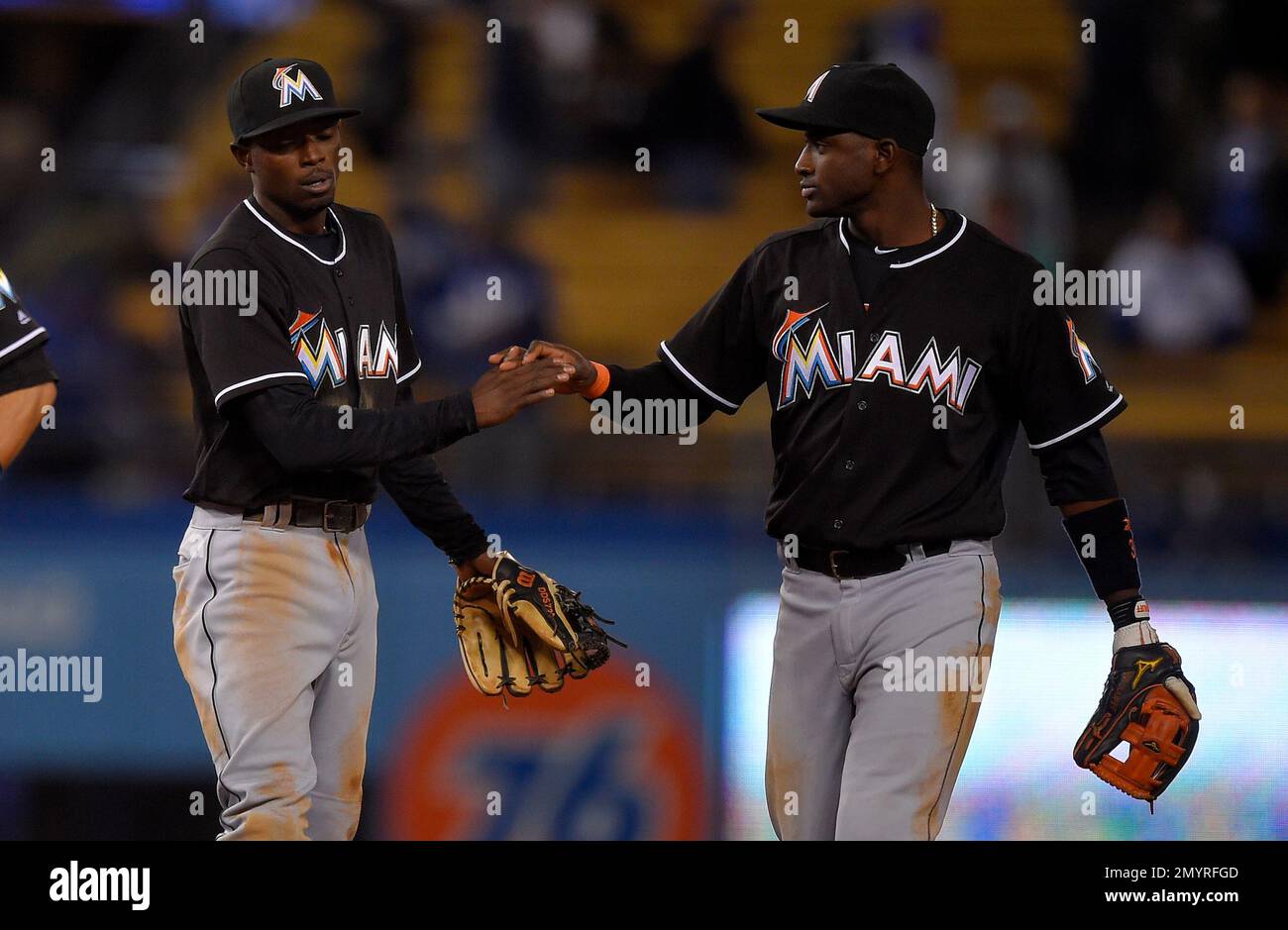 Miami Marlins second baseman Dee Gordon and shortstop Adeiny Hechavarria  congratulate each other after the Marlins defeated the Los Angeles Dodgers  5-3 in a baseball game, Thursday, April 28, 2016, in Los
