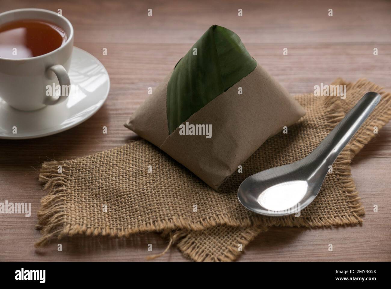 Nasi lemak , a popular malaysia breakfast serve with a cup of tea. Stock Photo