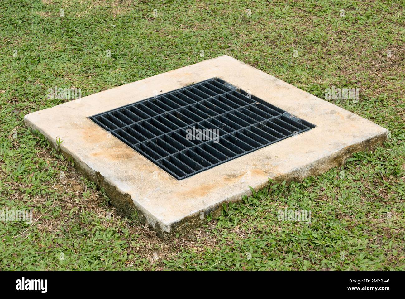Steel closed drain cover in the garden. Stock Photo