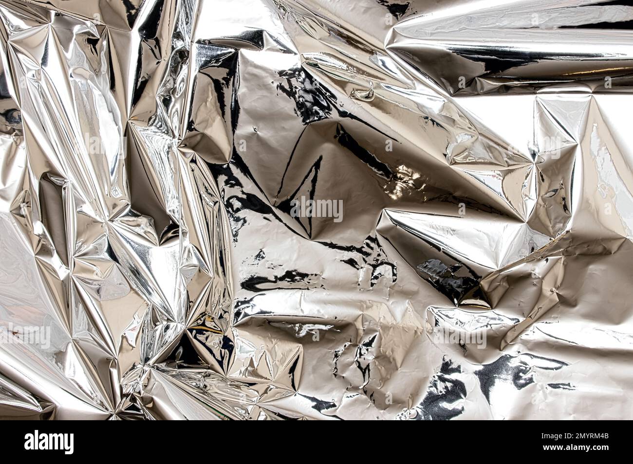 Shiny silver foil close-up. Abstract background, glossy surface Stock Photo