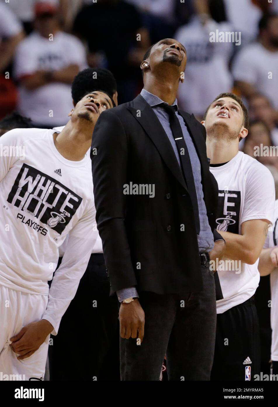 Miami Heat players Josh Richardson, left, Chris Bosh, center, and Tyler Johnson, right, look up as they watch a video replay during the final seconds of the second half in Game 5