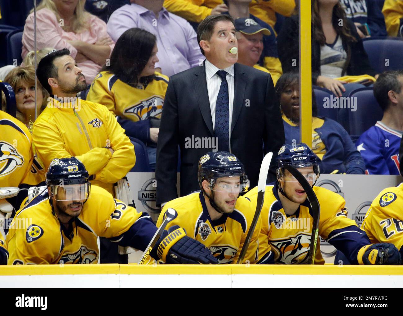 Nashville Predators head coach Peter Laviolette blows a bubble as he