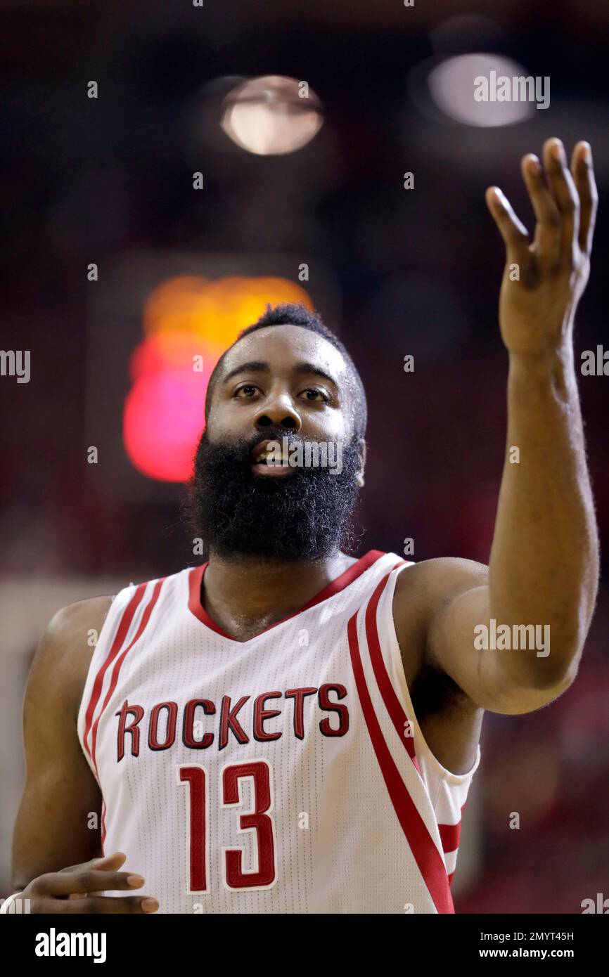 Houston Rockets' James Harden acknowledges the crowd after stealing the  ball and taking it to the basket for a dunk during the first half in Game 4  of a first-round NBA basketball