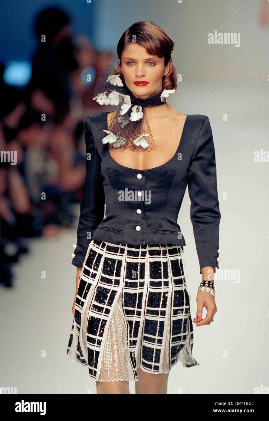 Danish top model Helena Christensen presents a black and white plaid skirt  with a short black jacket as part of Valentino's 1995 spring-summer ready -to-wear fashion collection in Paris, Oct. 16, 1994. (AP
