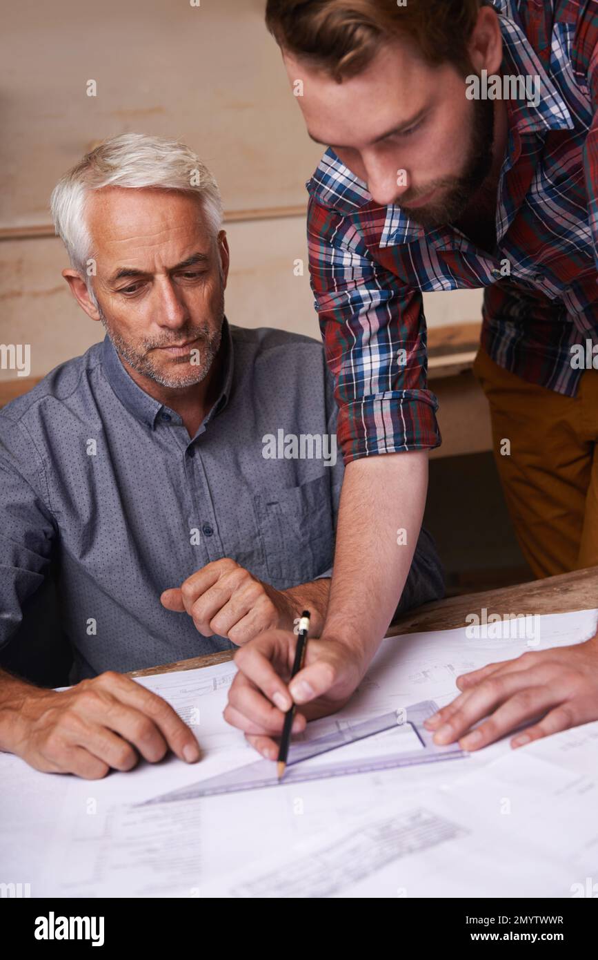 Turning his vision into reality. An architect drawing up plans Stock