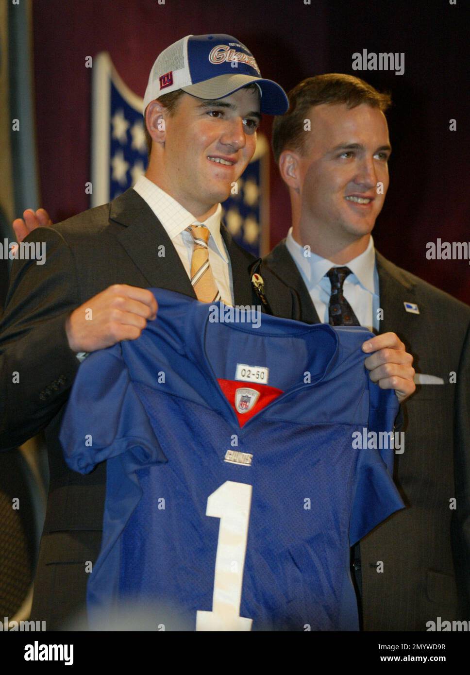 FILE - In this April 24, 2004 file photo, Eli Manning, quarterback from  Mississippi, holds up a New York Giants jersey while standing next to his  brother Peyton, quarterback for the Indianapolis