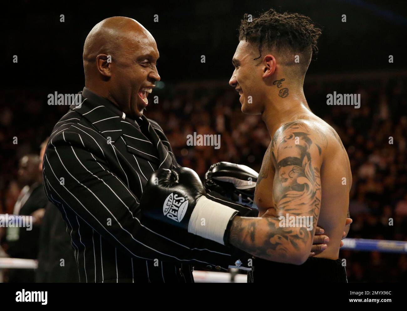 British boxing legend Nigel Benn, left, celebrates with his son Conor