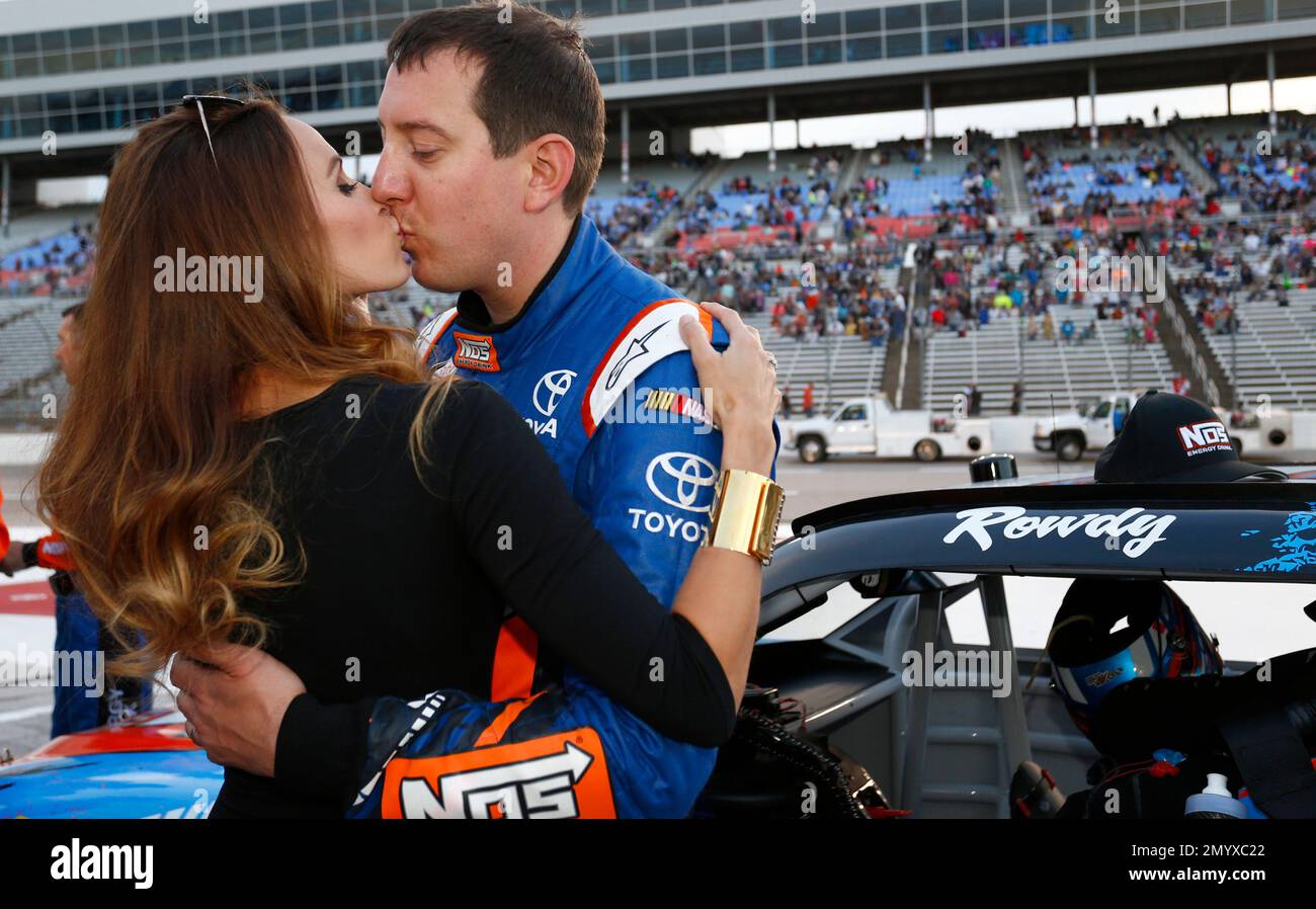 Kyle Busch, right, kisses his wife Samantha Busch before the start of the NASCAR Xfinity Series