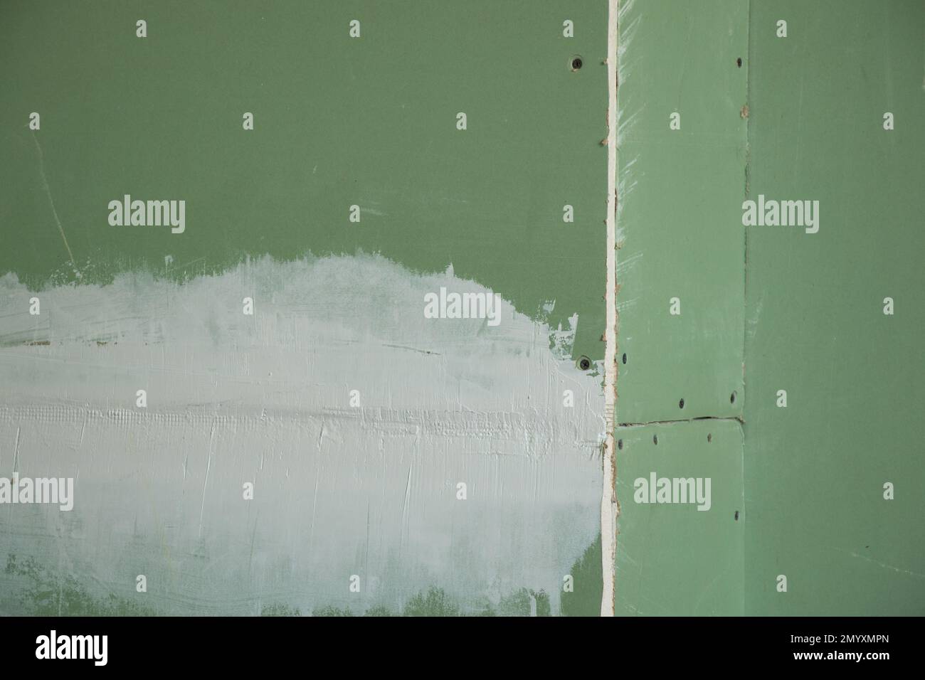 drywall wall of green color as a background Stock Photo Alamy