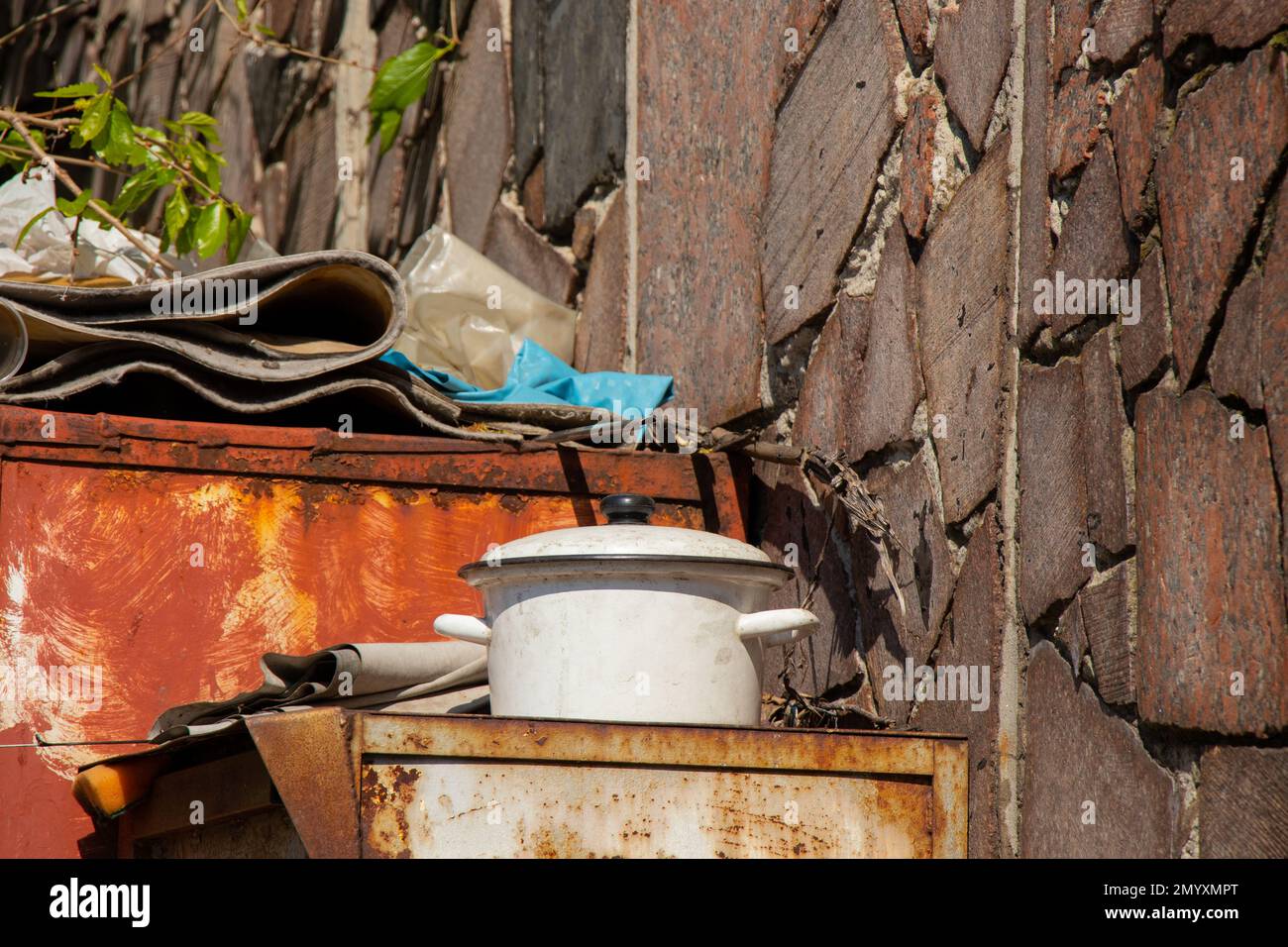 kitchen pot in a garbage dump on the street Stock Photo
