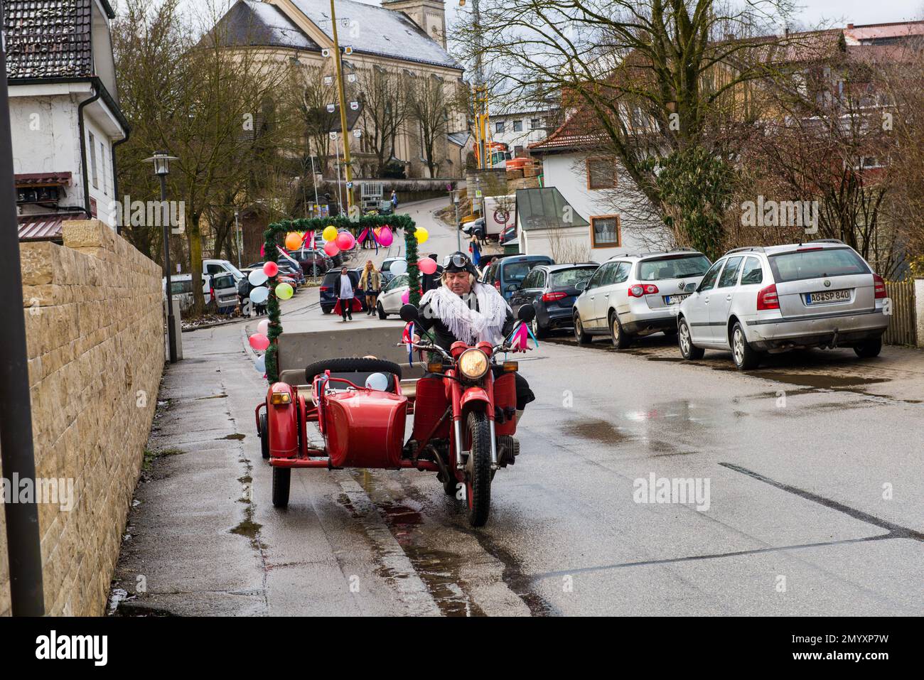 Halsbach,Germany-February 4,2023: People in opposite sex costumes take part in the city's Carnival Wedding Stock Photo
