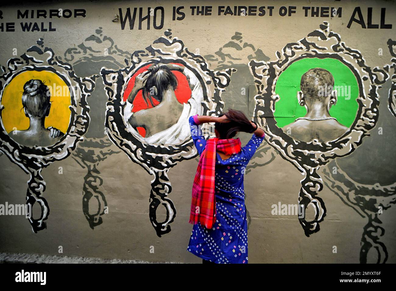Kolkata, India. 04th Feb, 2023. A young lady poses in front of a beautiful wall graffiti during an open air Art Fest. Kolkata streets and different slums seen getting painted with colorful graffitis as an initiative of an ongoing Art Fest (Behala Art Fest). Artists from different art colleges have participated to make the city more beautiful. Credit: SOPA Images Limited/Alamy Live News Stock Photo