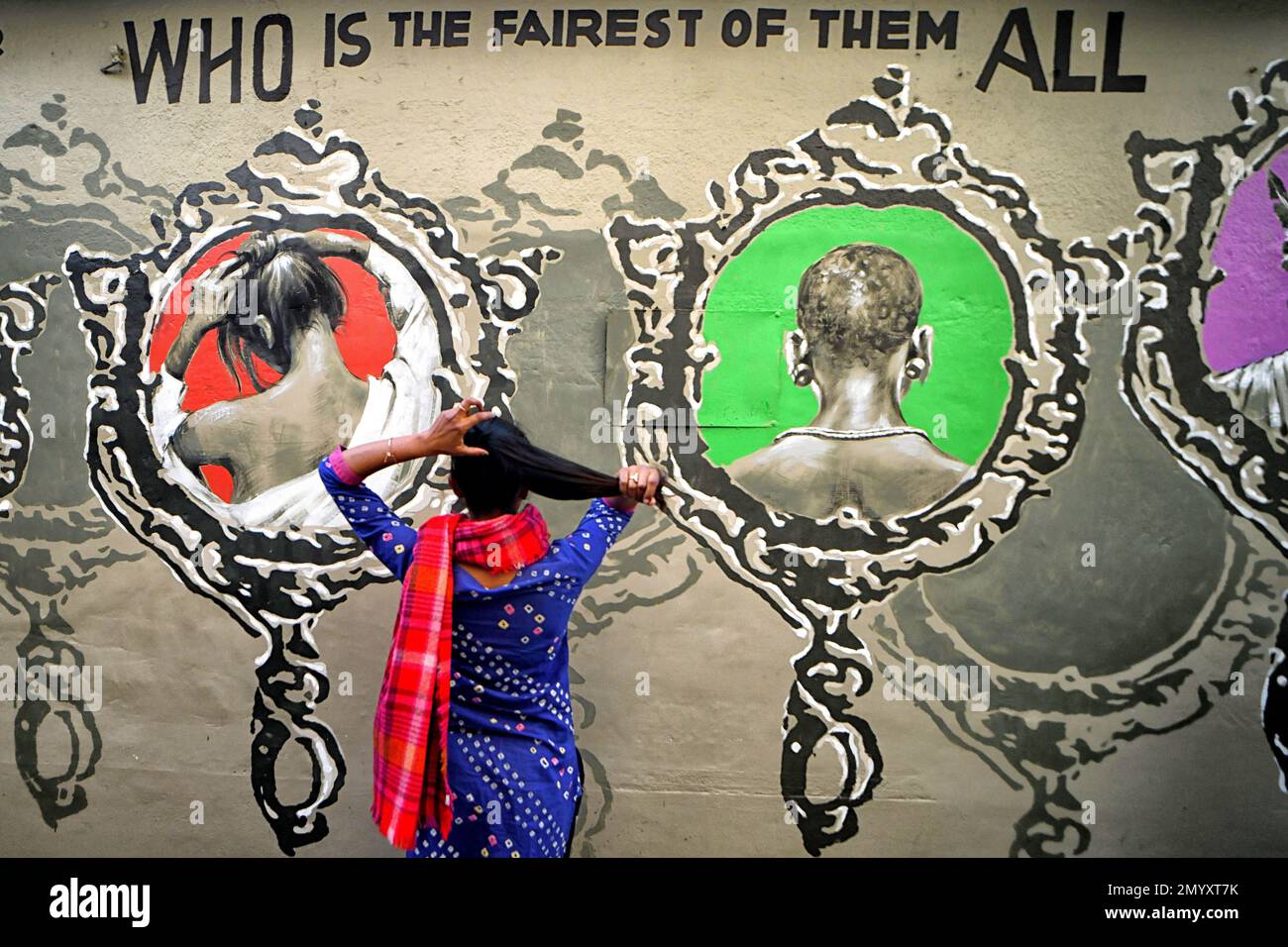 Kolkata, India. 04th Feb, 2023. A young lady poses in front of a beautiful wall graffiti during an open air Art Fest. Kolkata streets and different slums seen getting painted with colorful graffitis as an initiative of an ongoing Art Fest (Behala Art Fest). Artists from different art colleges have participated to make the city more beautiful. Credit: SOPA Images Limited/Alamy Live News Stock Photo