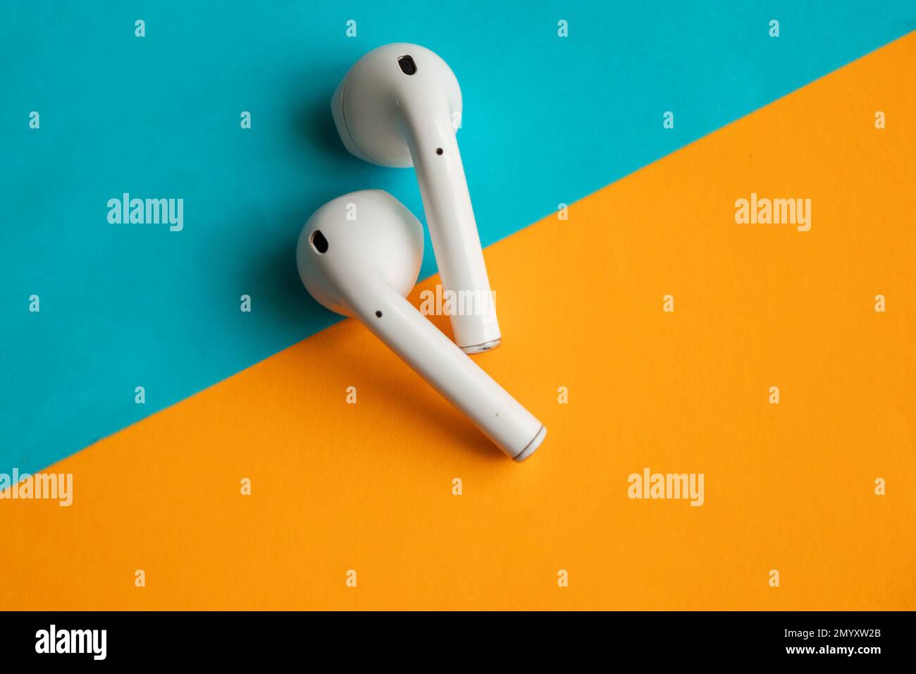 wireless headphones lie on a colorful background Stock Photo