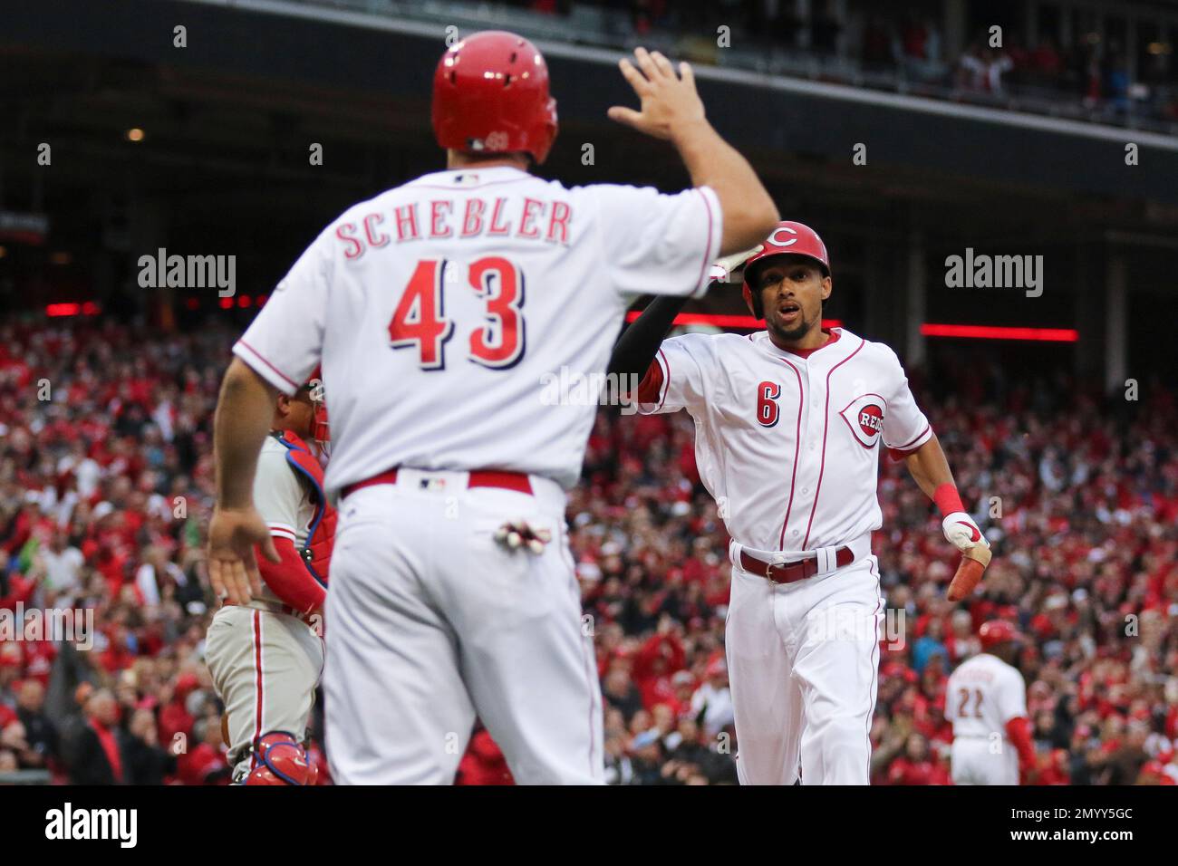 Cincinnati Reds' Billy Hamilton (6) celebrates with Scott Schebler (43)  after scoring on a two-run single hit by Joey Votto, not pictured, in the  eighth inning of their opening day baseball game