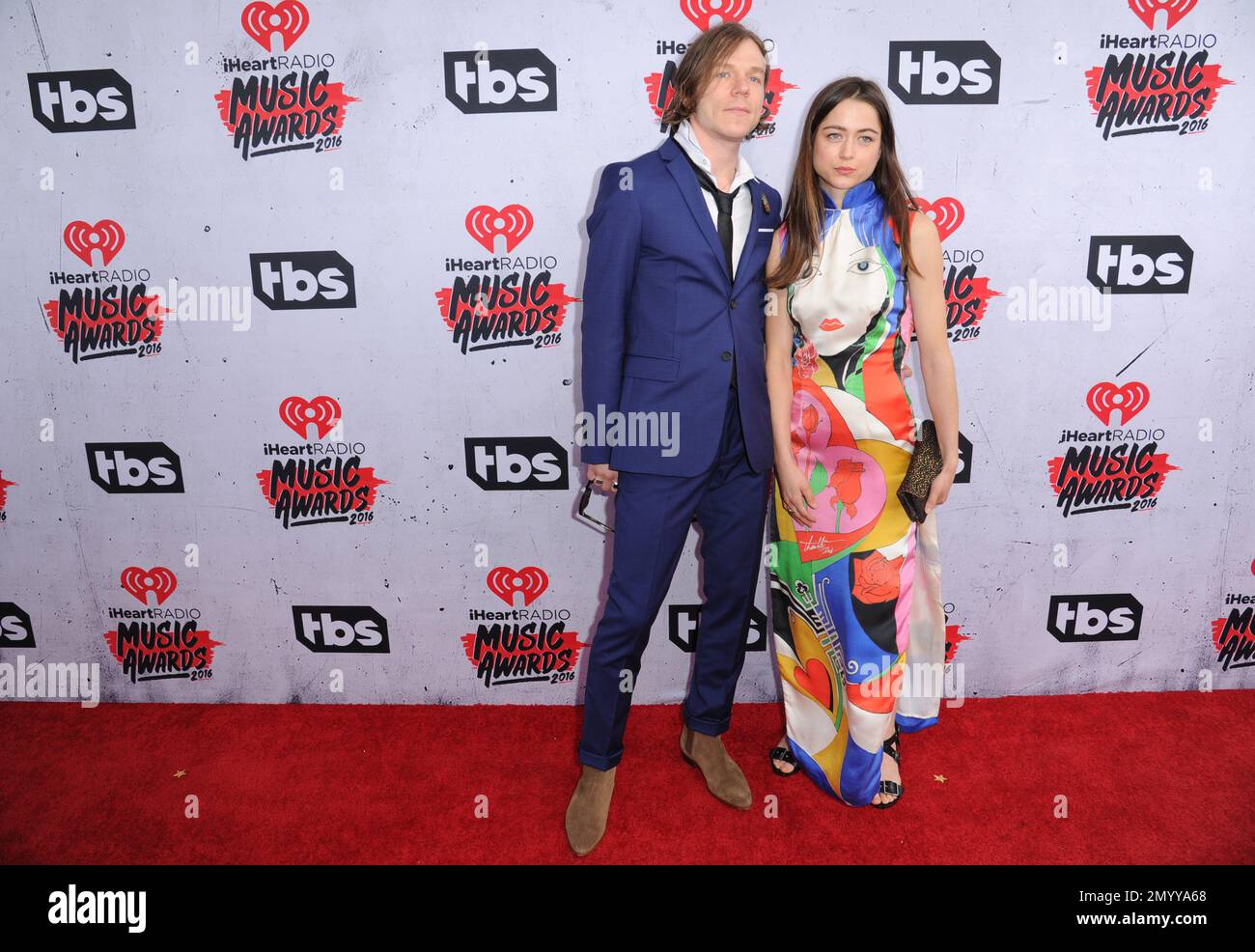 Matt Shultz of Cage the Elephant, left, and Juliette Buchs arrive at the  iHeartRadio Music Awards at The Forum on Sunday, April 3, 2016, in  Inglewood, Calif. (Photo by Richard Shotwell/Invision/AP Stock