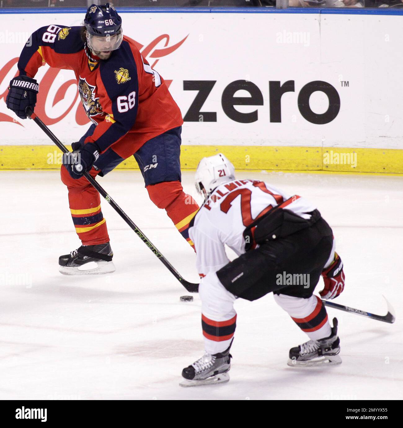 Florida Panthers' Jaromir Jagr (68), of the Czech Republic, moves the puck  as New Jersey Devils' Kyle Palmieri (21) defends during the first period of  an NHL hockey game, Thursday, March 31,