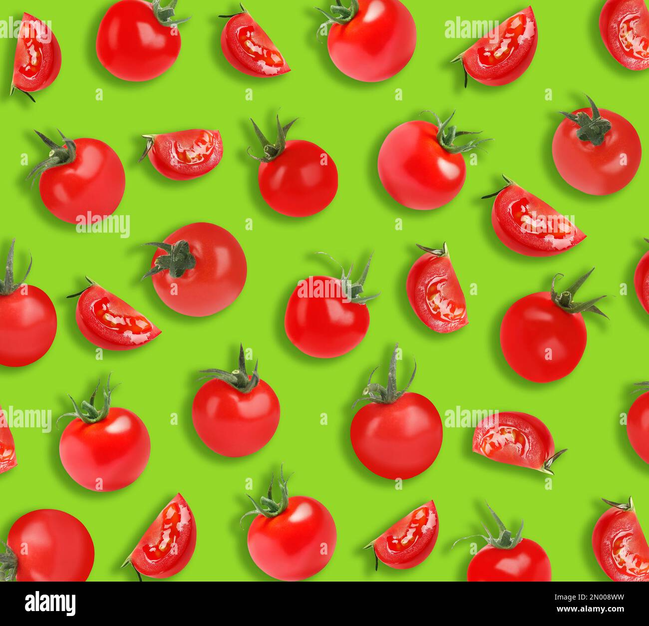 Fresh tomatoes on green background. Pattern design Stock Photo