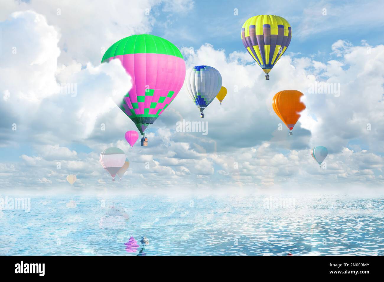 Fantastic dreams. Hot air balloons in sky with fluffy clouds over sea