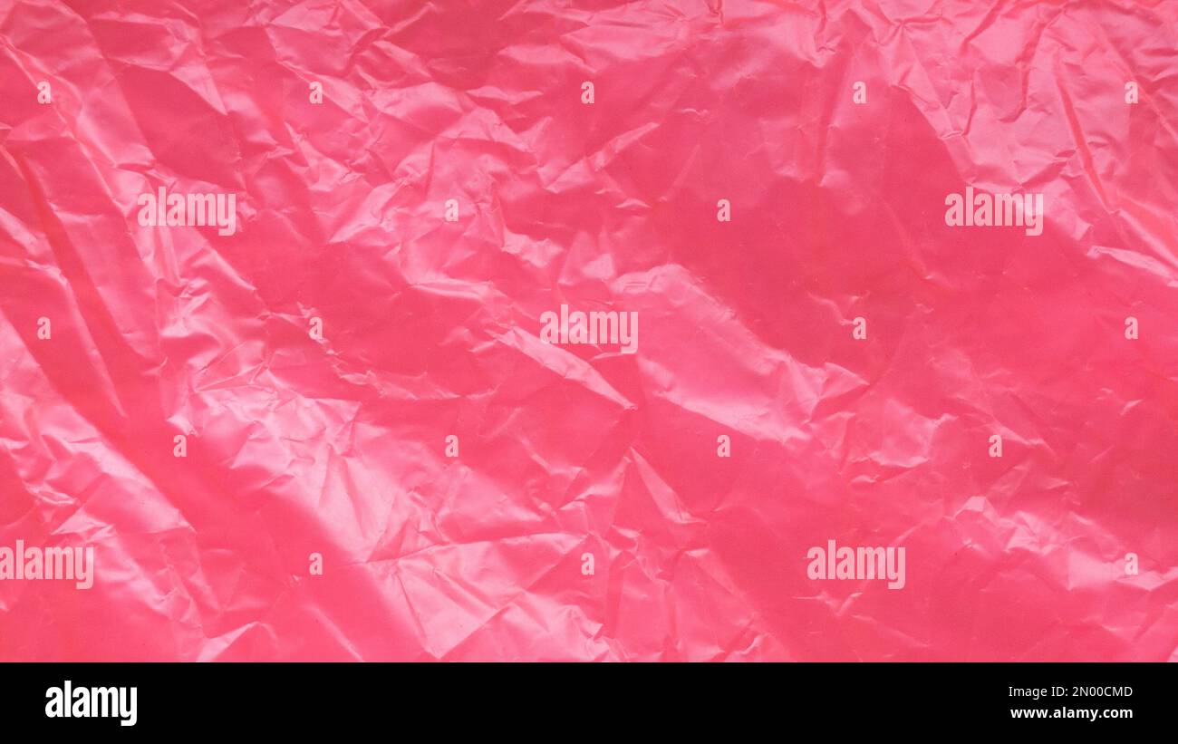 Red and crumpled plastic bag background and texture. Stock Photo