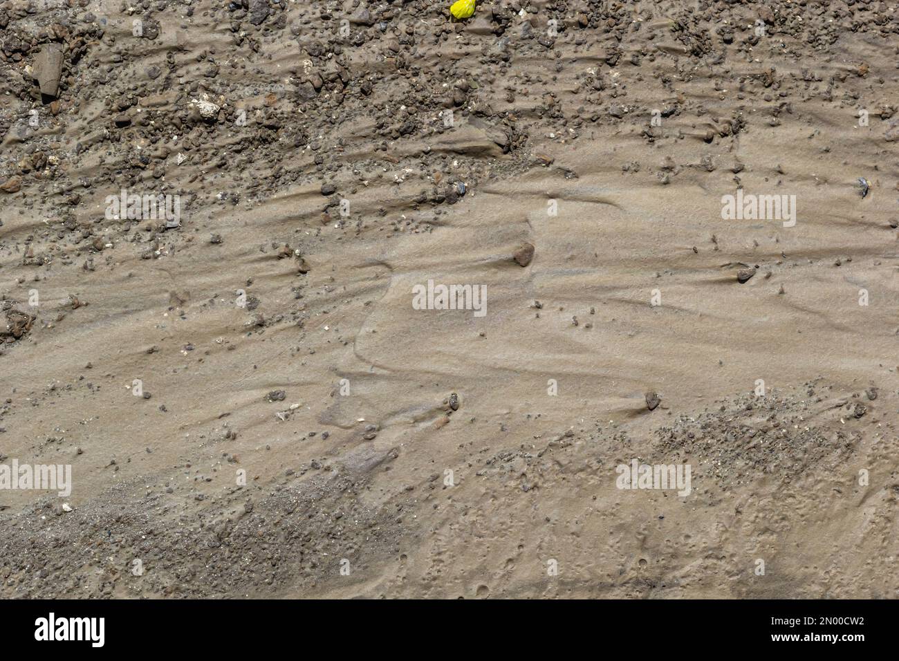 Dirty washed dirt road with traces of water flow in spring. Off-road. Stock Photo