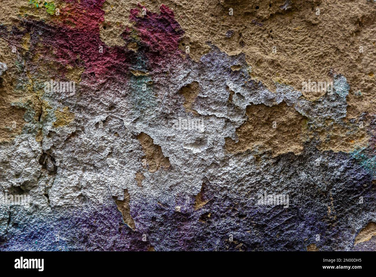 Brick wall with multi-colored paint close-up. Background brick creative. Stock Photo